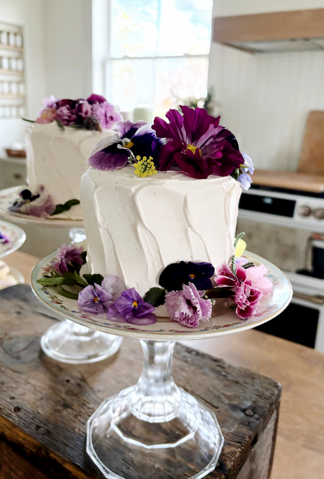 small vanilla cake decorated with colorful edible flowers